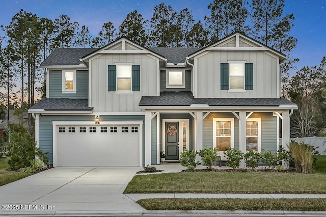 view of front of home featuring a garage and a yard