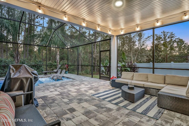 patio terrace at dusk with area for grilling and an outdoor living space