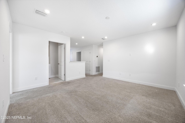 unfurnished room with light colored carpet