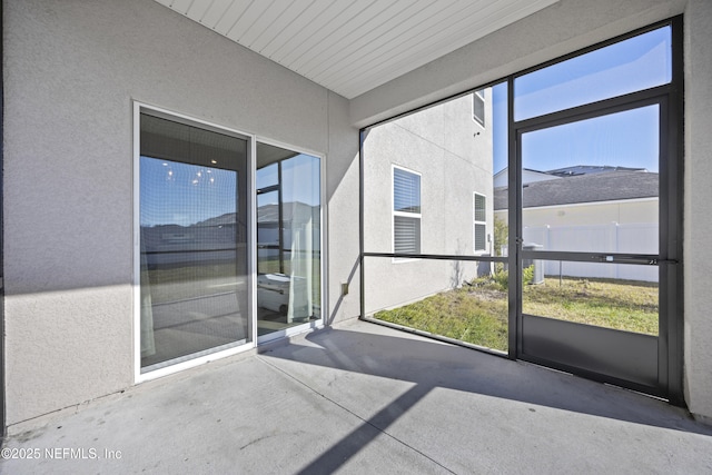 unfurnished sunroom featuring a wealth of natural light and wood ceiling