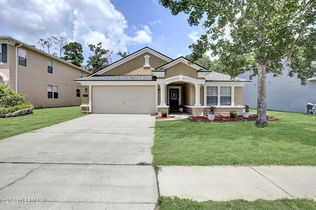 ranch-style home with a front yard and a garage