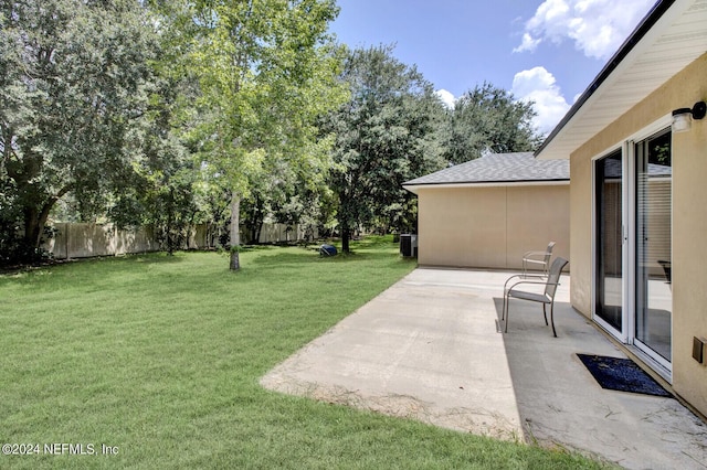 view of yard featuring a patio and central AC