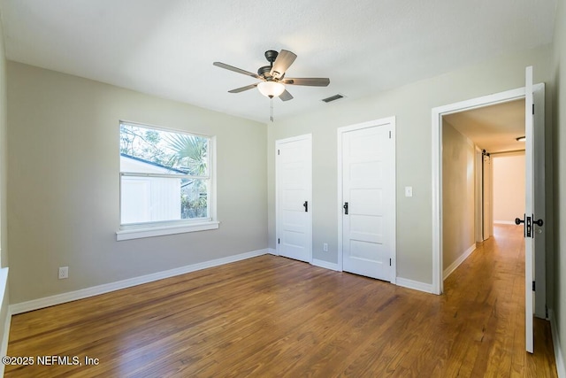 unfurnished bedroom featuring ceiling fan and hardwood / wood-style flooring