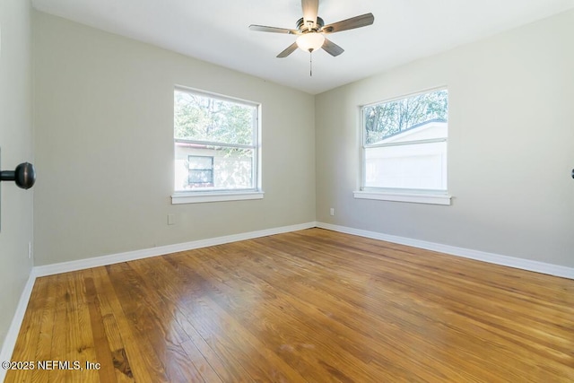 unfurnished room featuring ceiling fan and hardwood / wood-style flooring