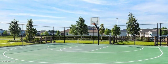 view of sport court with a yard