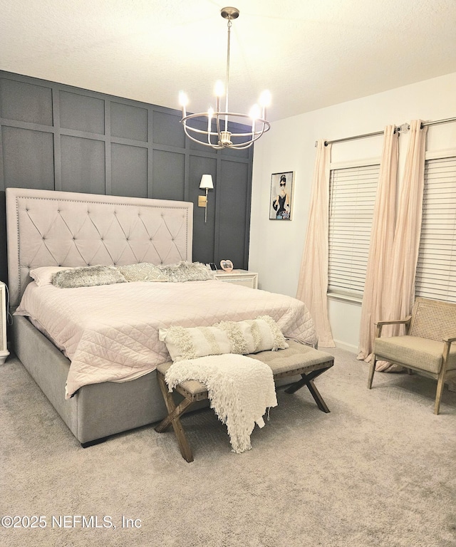 bedroom with carpet and a notable chandelier