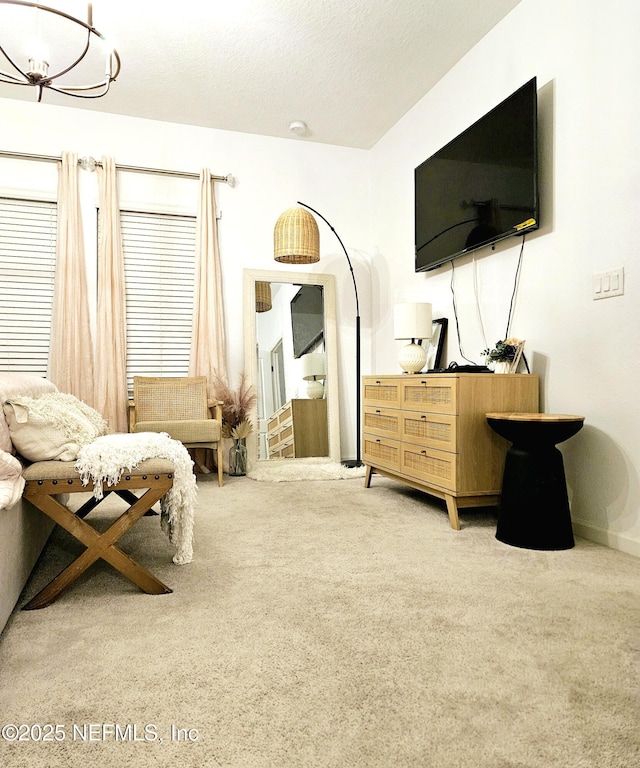 interior space featuring carpet flooring and a notable chandelier