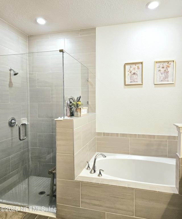 bathroom with vanity, a textured ceiling, and shower with separate bathtub