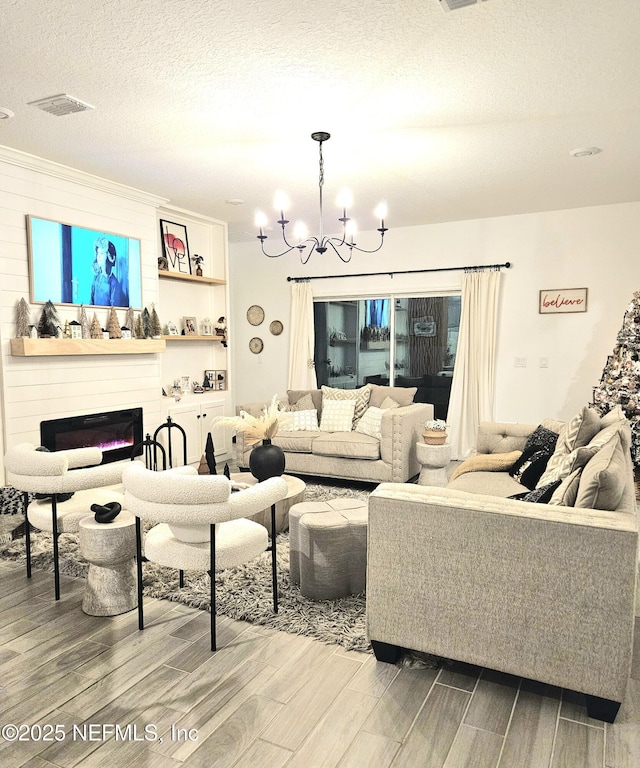 living room with a textured ceiling and a notable chandelier