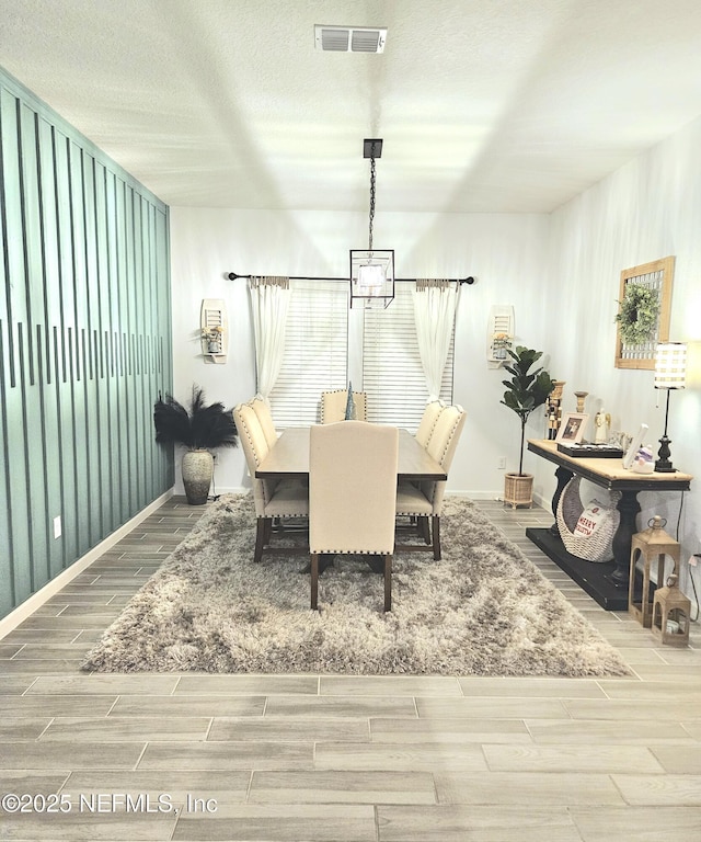 dining area featuring a textured ceiling