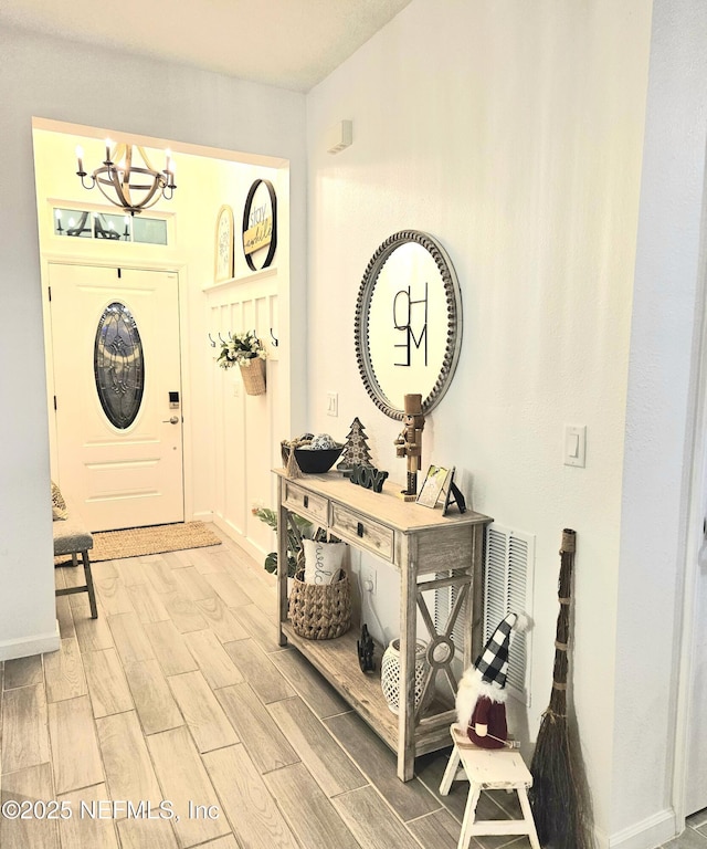 foyer entrance with an inviting chandelier