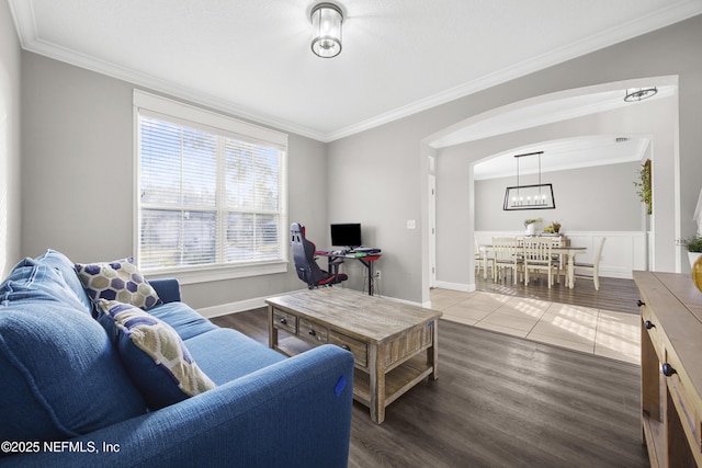 living room featuring a chandelier, ornamental molding, and hardwood / wood-style floors