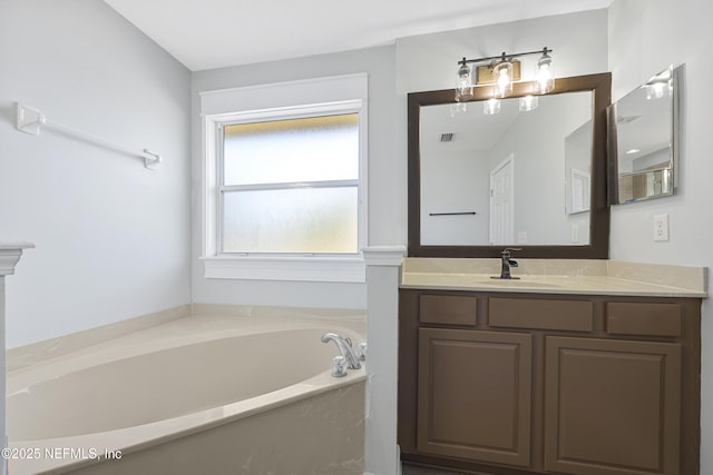 bathroom with a washtub and vanity