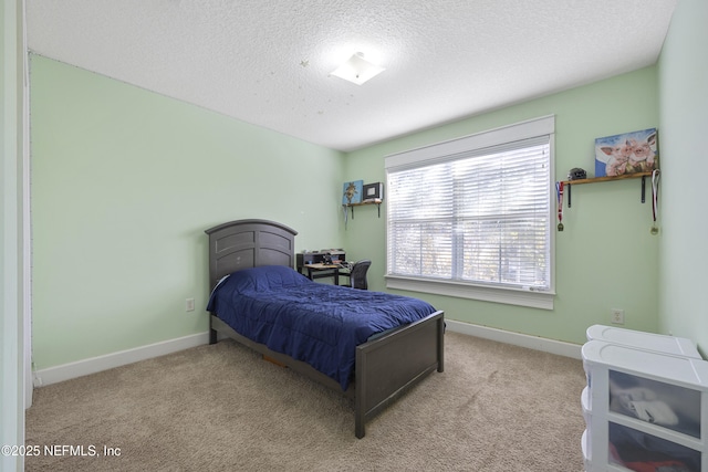 bedroom with a textured ceiling and light carpet