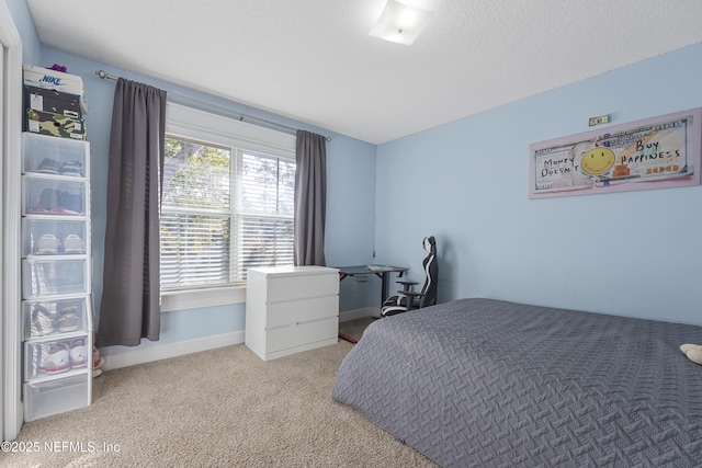 bedroom featuring light carpet and a textured ceiling