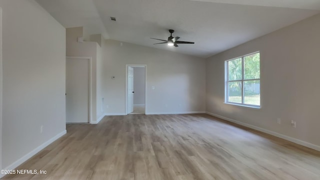 unfurnished room featuring ceiling fan, lofted ceiling, and light wood-type flooring