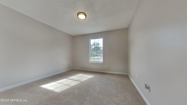 empty room featuring carpet flooring and a textured ceiling