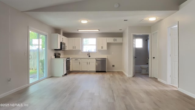 kitchen featuring a wealth of natural light, white cabinetry, sink, and appliances with stainless steel finishes