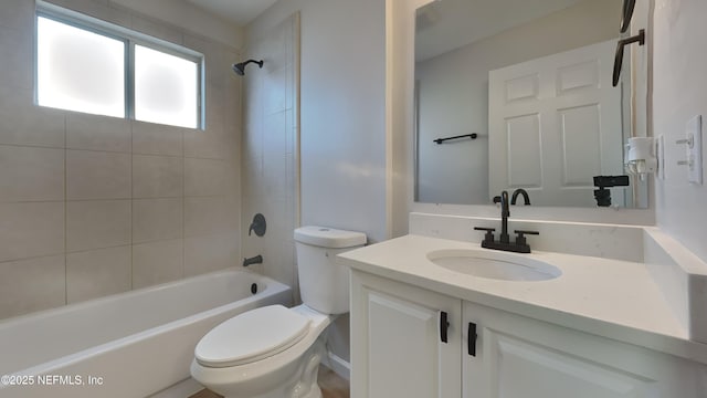 full bathroom with vanity, toilet, and tiled shower / bath