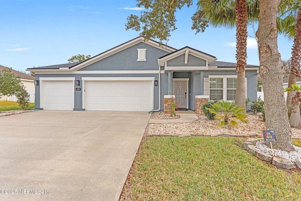 view of front facade with a front yard and a garage