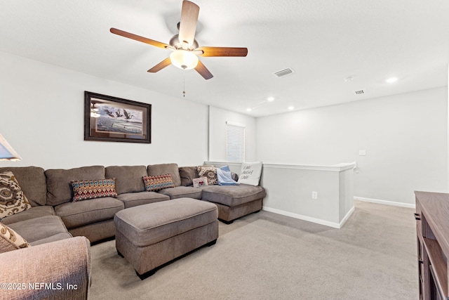 carpeted living room featuring ceiling fan