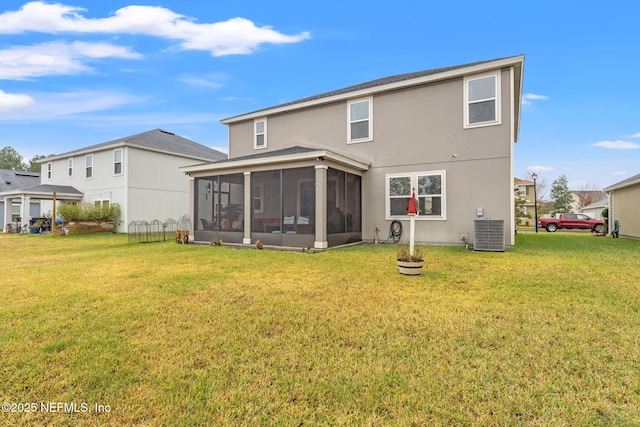 back of house with a sunroom, central air condition unit, and a lawn