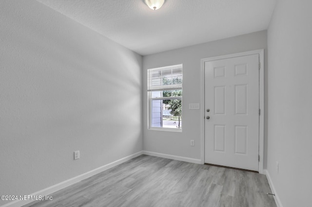 unfurnished room with light wood-type flooring