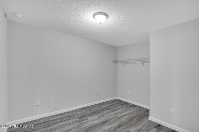 interior space with wood-type flooring and a textured ceiling