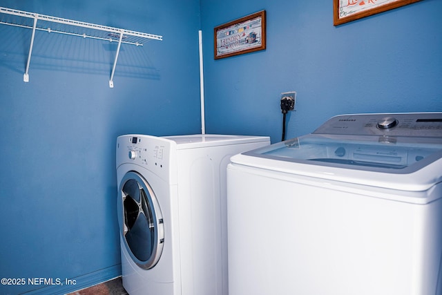 washroom with washing machine and clothes dryer