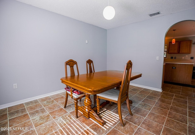 dining room featuring a textured ceiling