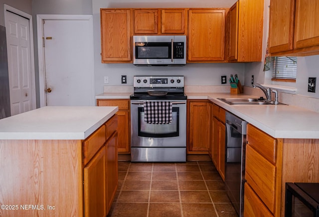 kitchen with dark tile patterned floors, sink, a kitchen island, and black appliances