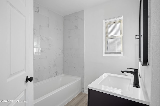 bathroom featuring shower / bathtub combination, hardwood / wood-style flooring, and vanity