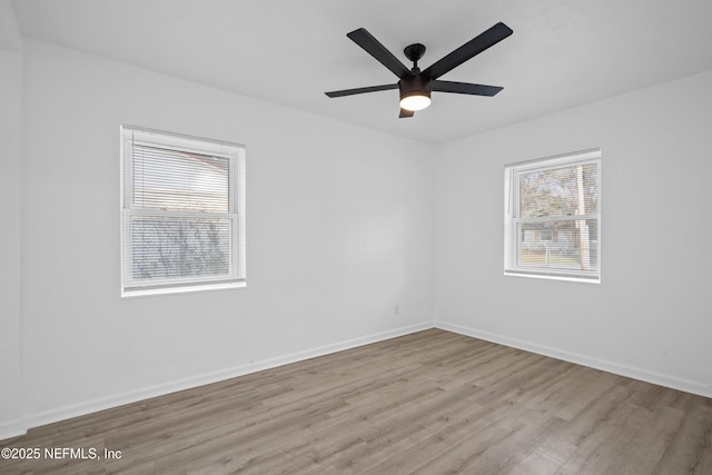 spare room featuring light wood-type flooring and ceiling fan
