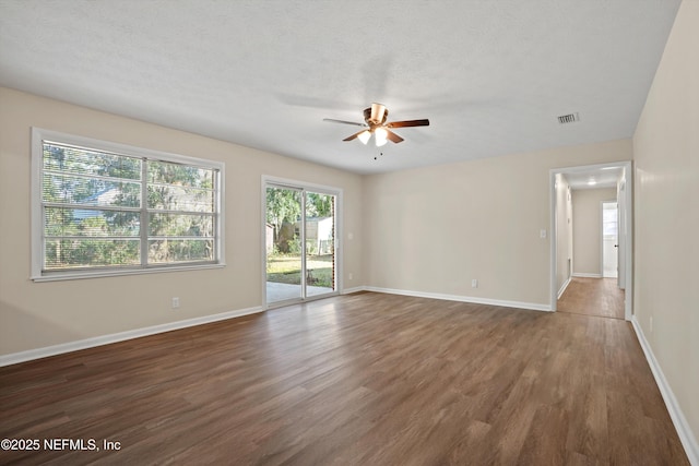 spare room featuring a textured ceiling, ceiling fan, and dark hardwood / wood-style flooring