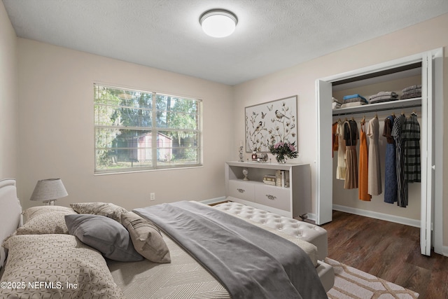 bedroom featuring dark wood-type flooring, a textured ceiling, and a closet