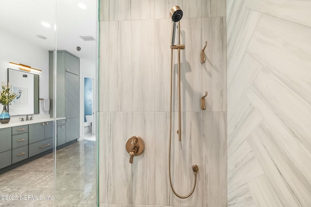 bathroom with a shower, vanity, and toilet