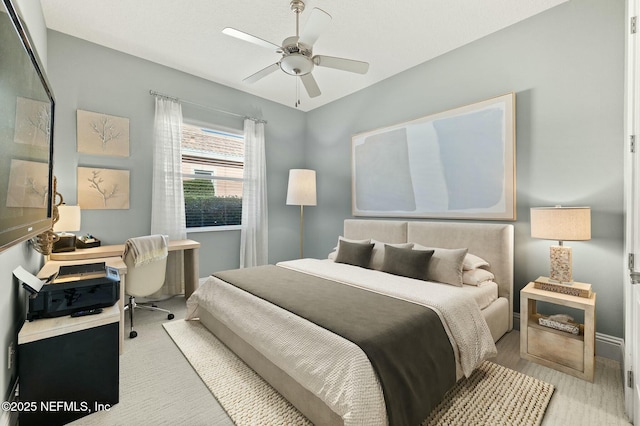 bedroom with ceiling fan and light hardwood / wood-style flooring