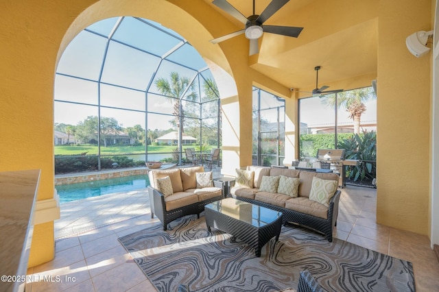 view of patio / terrace with an outdoor hangout area, ceiling fan, a lanai, a grill, and exterior kitchen