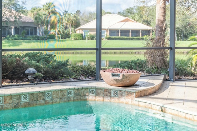 view of swimming pool with a yard and a water view