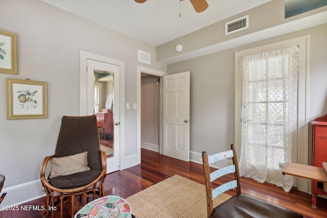 sitting room featuring ceiling fan and dark wood-type flooring