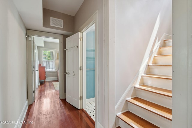 stairway with hardwood / wood-style floors