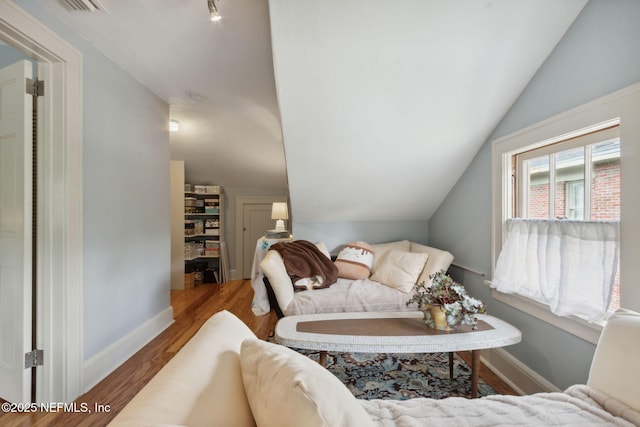 living room with vaulted ceiling and wood-type flooring