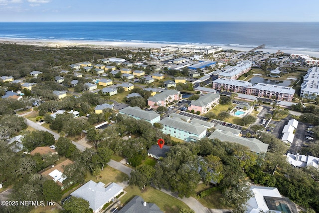 aerial view with a water view and a beach view