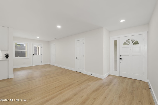 foyer entrance with light hardwood / wood-style flooring