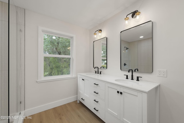 bathroom with vanity, a shower, and hardwood / wood-style flooring