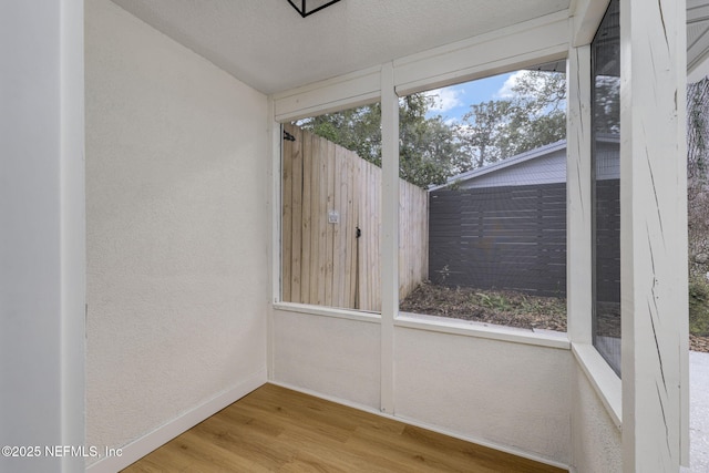 unfurnished sunroom featuring a wealth of natural light