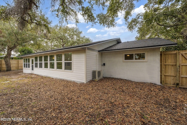 back of house with ac unit