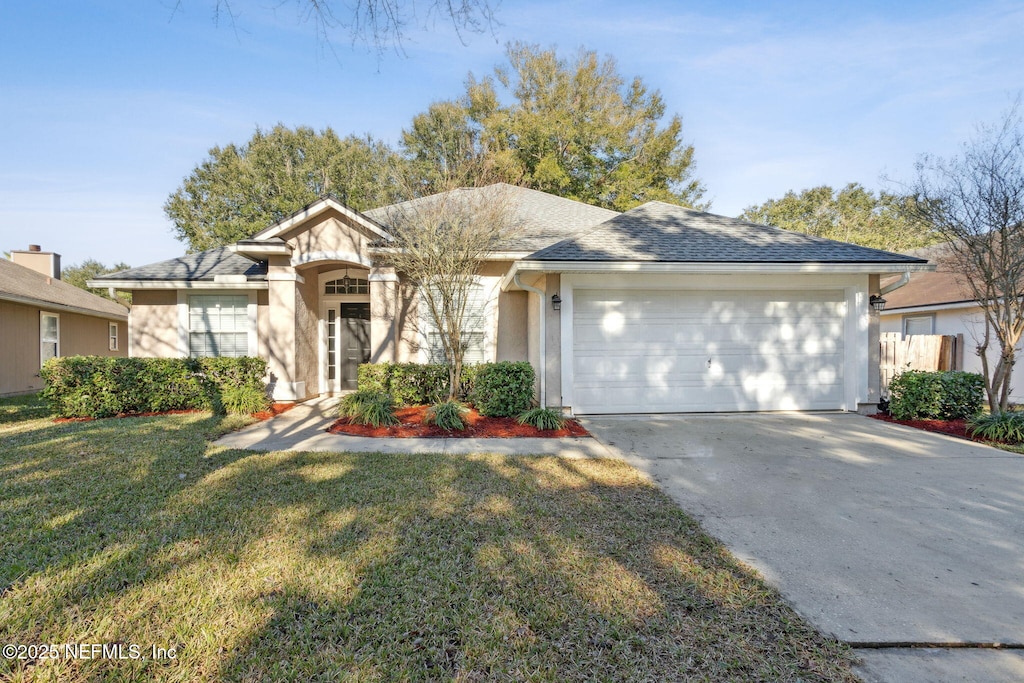 single story home featuring a front yard and a garage