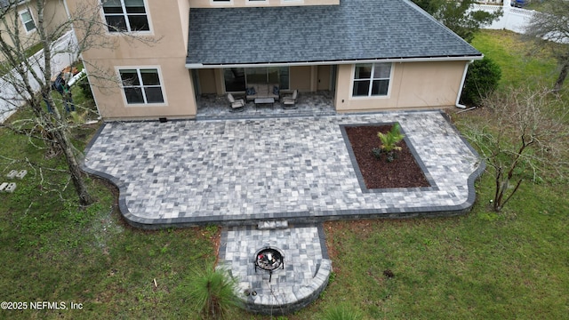 rear view of property featuring an outdoor hangout area, a yard, and a patio area