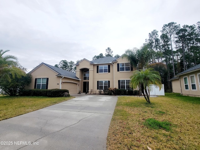 view of front facade featuring a front yard and a garage